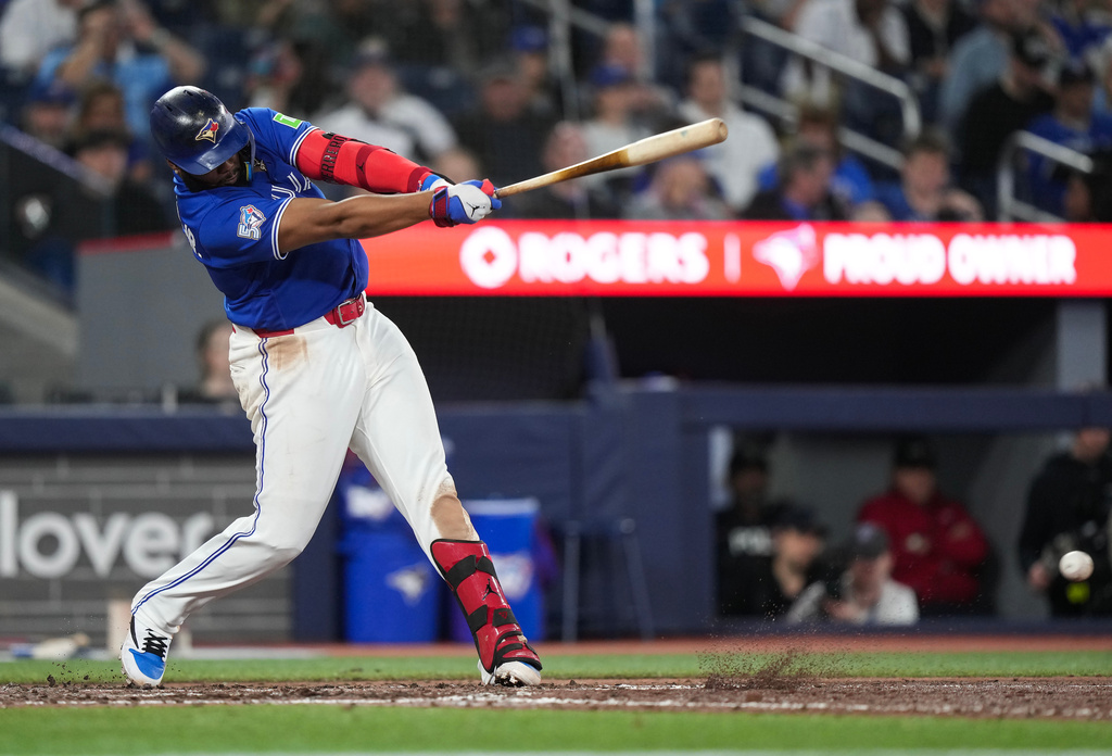 Toronto Blue Jays' Vladimir Guerrero Jr. hits a single against the Minnesota Twins during seventh-inning baseball game action in Toronto, Sunday, April 12, 2026. (Nathan Denette/The Canadian Press via AP)