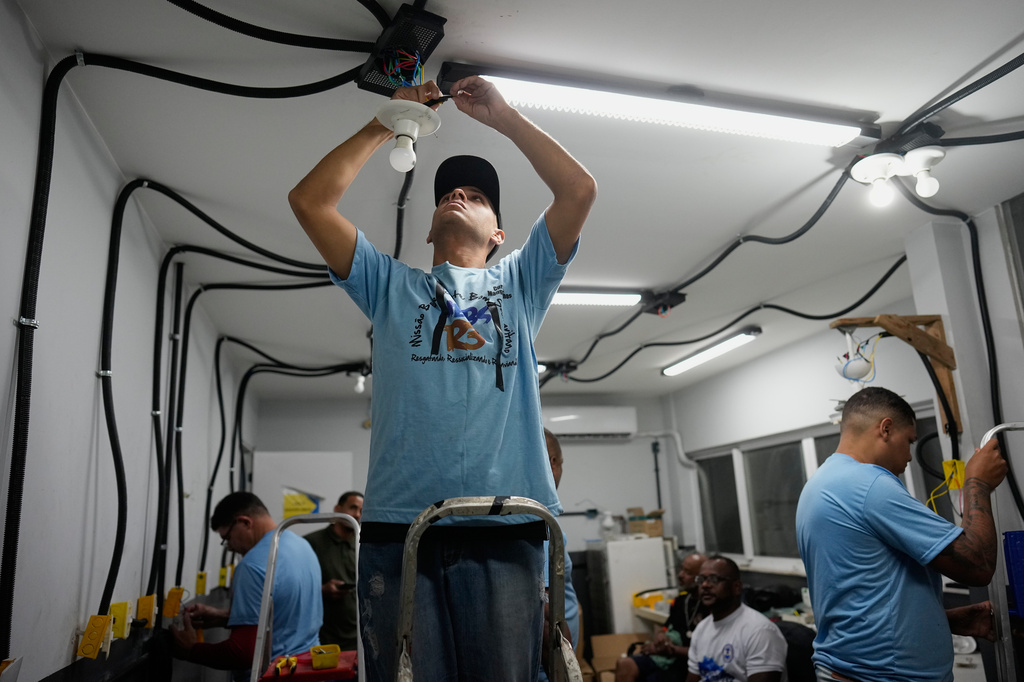 A youth attends an electricity course at a therapeutic community named "R3," which stands for Rescuing, Resocializing and Resending, in Rio de Janeiro, Monday, Sept. 14, 2026. (AP Photo/Silvia Izquierdo)