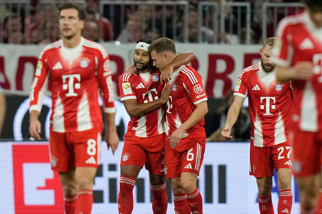 Bayern's Serge Gnabry, center left, celebrates with Bayern's Joshua Kimmich after scoring his side's opening goal during the German Bundesliga soccer match between Bayern Munich and Bayern Leverkusen in Munich, Germany, Saturday, Nov. 1, 2025. (AP Photo/Matthias Schrader)