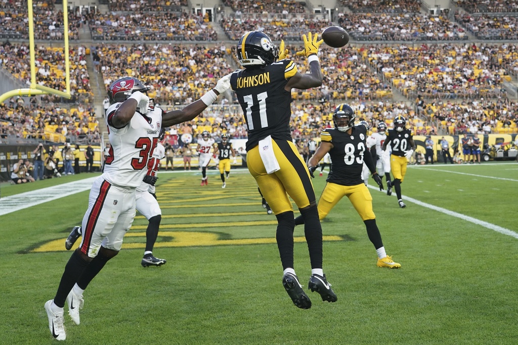 Pittsburgh Steelers wide receiver Brandon Johnson (11) catches a pass from quarterback Mason Rudolph for a touchdown with Tampa Bay Buccaneers cornerback Jacob Parrish defending during the first half of an NFL football preseason game, Saturday, Aug. 16, 2025 in Pittsburgh. (AP Photo/Matt Freed)