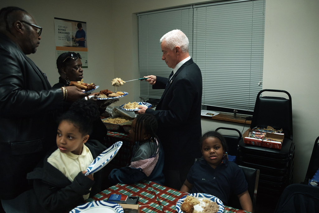 Jersey City mayoral candidate Jim McGreevey serves food to attendees at a community event on Wednesday, Oct. 29, 2025, in Jersey City, N.J. (AP Photo/Andres Kudacki)