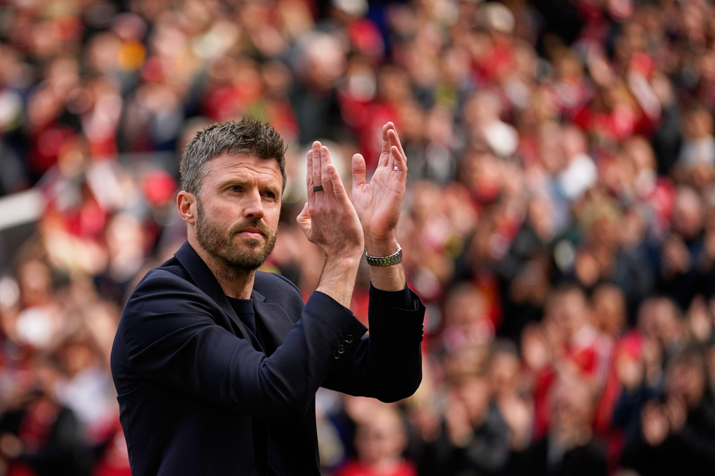 Manchester United's interim head coach Michael Carrick applauds supporters after the English Premier League soccer match between Manchester United and Nottingham Forest in Manchester, England, Sunday, May 17, 2026. (AP Photo/Dave Thompson)