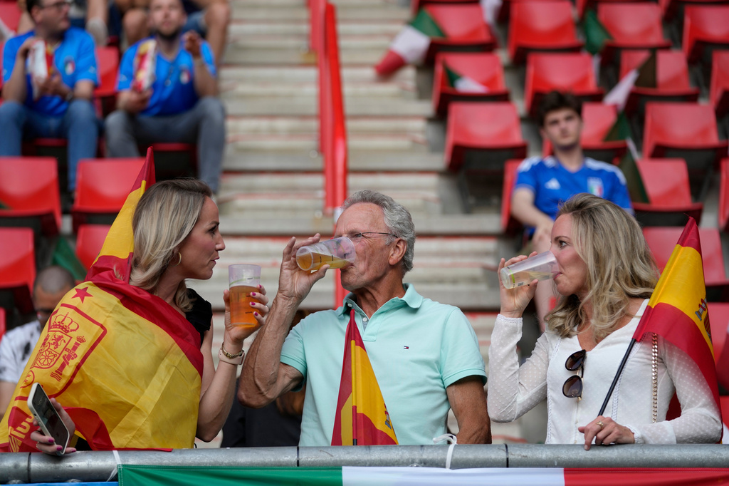 FILE - Fans have a drink on the stands while waiting for the start of the Nations League semifinal soccer match between Spain and Italy at De Grolsch Veste stadium in Enschede, eastern Netherlands, June 15, 2023. (AP Photo/Peter Dejong, File)
