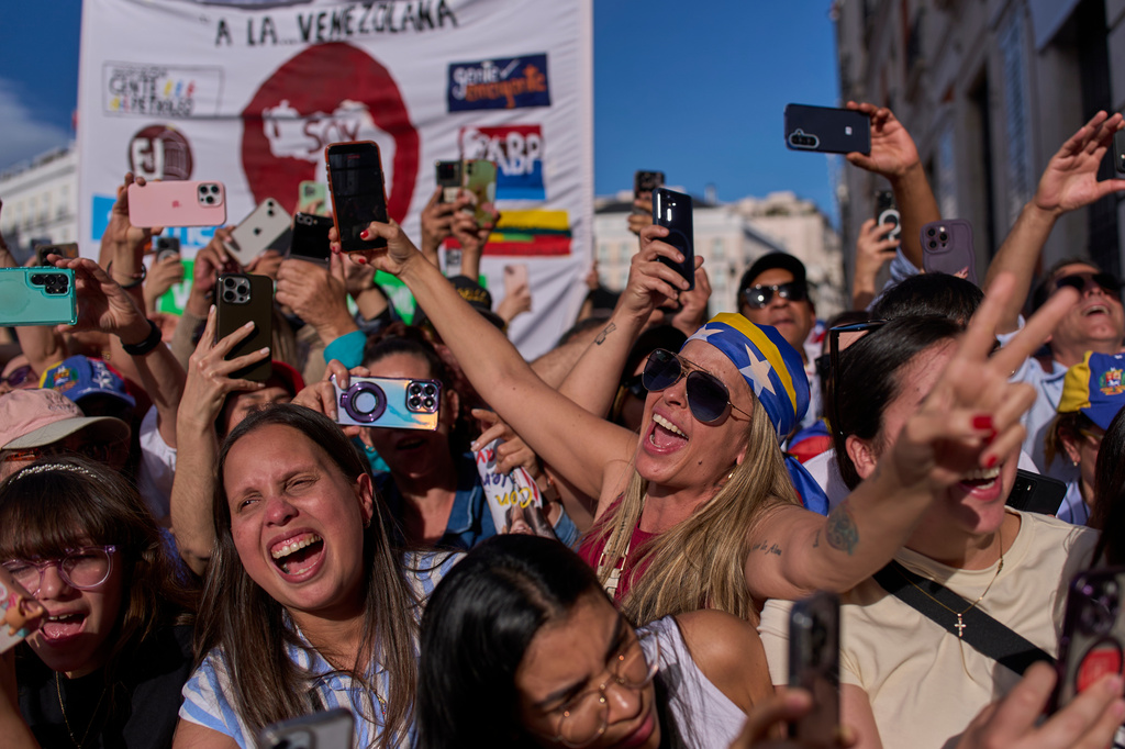 Venezuelan supporters react as Venezuela's opposition leader Maria Corina Machado delivers a speech at Madrid's Puerta del Sol, in Madrid, Spain, Saturday, April 18, 2026. (AP Photo/Manu Fernandez)