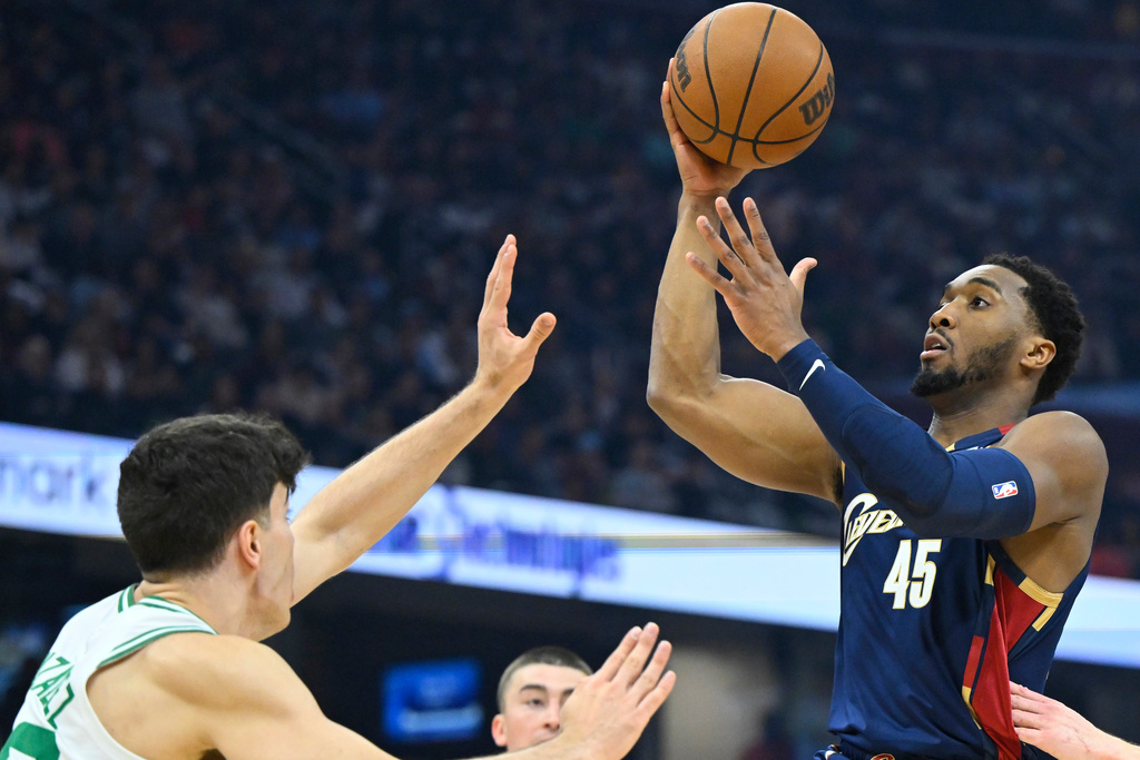 Cleveland Cavaliers guard Donovan Mitchell (45) drives to the basket in the first half of an NBA basketball game in Cleveland, Sunday, March 8, 2026. (AP Photo/David Richard)