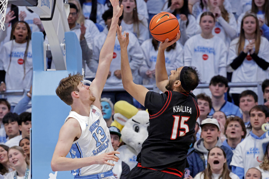 Louisville center Aly Khalifa (15) shoots over North Carolina center Henri Veesaar (13) during the first half of an NCAA college basketball game Monday, Feb. 23, 2026, in Chapel Hill, N.C. (AP Photo/Chris Seward)