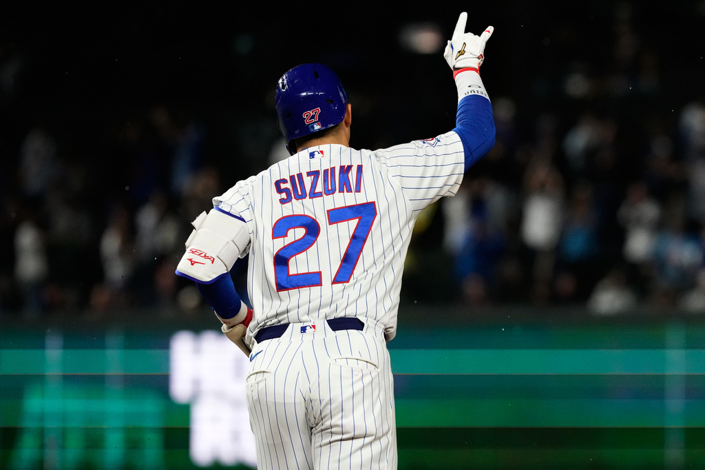 Chicago Cubs' Seiya Suzuki, of Japan, celebrates as he rounds the bases after hitting a three-run home run during the fourth inning of a baseball game against the Cincinnati Reds in Chicago, Monday, May 4, 2026. (AP Photo/Nam Y. Huh)