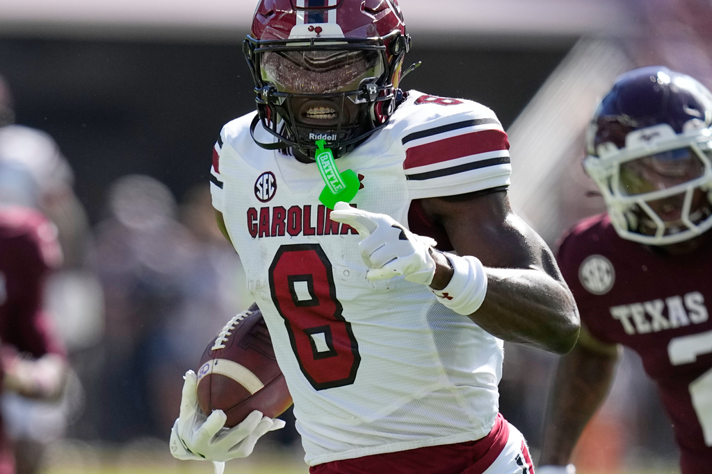 South Carolina wide receiver Nyck Harbor (8) runs for a touchdown after catching a pass as Texas A&M cornerback Dezz Ricks (2) defends during the first half of an NCAA college football game Saturday, Nov. 15, 2025, in College Station, Texas. (AP Photo/David J. Phillip)