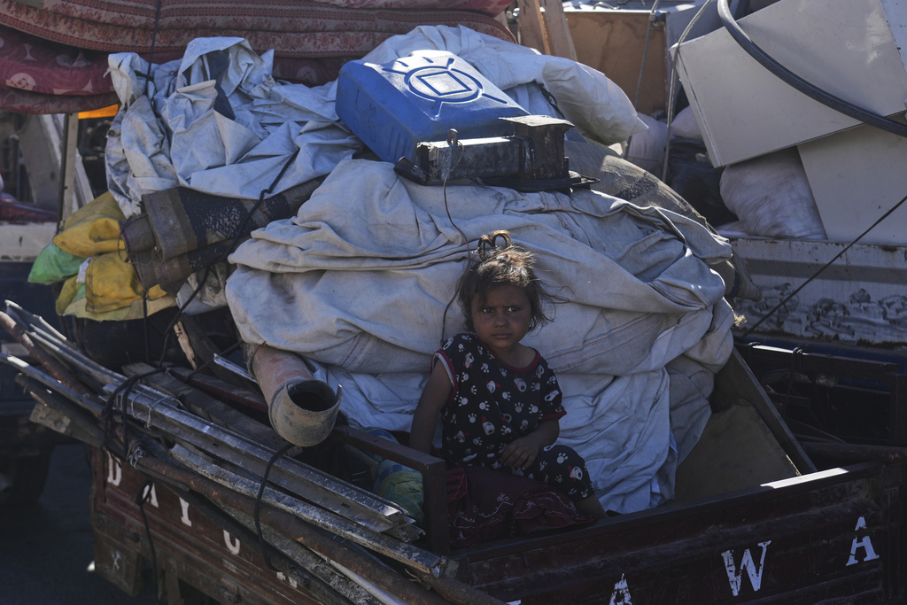 Displaced Palestinians fleeing northern Gaza carry their belongings along the coastal road toward southern Gaza, Wednesday, Sept. 10, 2025, after the Israeli army issued evacuation orders from Gaza City. (AP Photo/Abdel Kareem Hana)