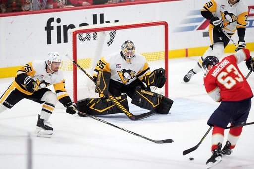 Florida Panthers left wing Brad Marchand (63) scores his team's third goal past Pittsburgh Penguins goaltender Tristan Jarry (35) and defenseman Connor Clifton (75) during the third period of an NHL hockey game, Thursday, Oct. 23, 2025, in Sunrise, Fla. (AP Photo/Rebecca Blackwell) Florida Panthers left wing Brad Marchand (63) scores his team's third goal past Pittsburgh Penguins goaltender Tristan Jarry (35) and defenseman Connor Clifton (75) during the third period of an NHL hockey game, Thursday, Oct. 23, 2025, in Sunrise, Fla. (AP Photo/Rebecca Blackwell)