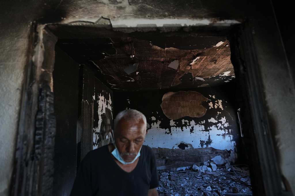 A resident inspects his home, which was burned during an Israeli military operation, in Zawtar al-Gharbieh, Lebanon, Tuesday, July 28, 2026. (AP Photo/Hassan Ammar)