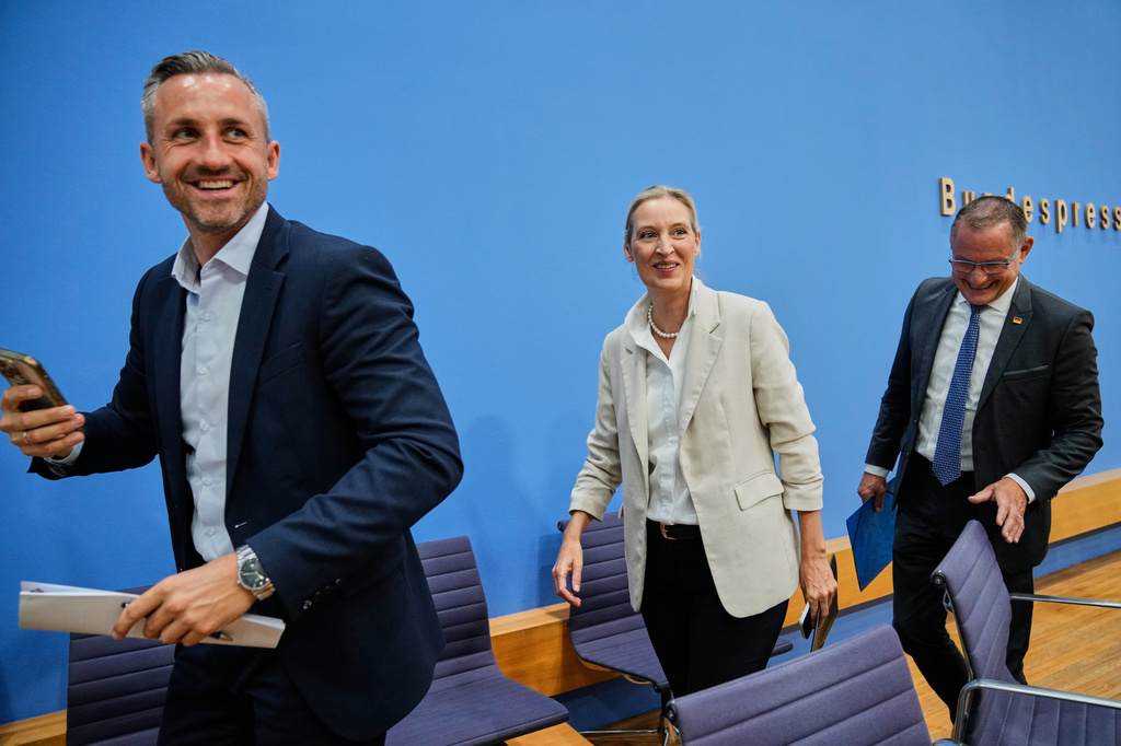 Co-leaders of Alternative for Germany party, or AfD, Alice Weidel, center, and Tino Chrupalla, right, and top candidate for the Saxony-Anhalt state elections Ulrich Siegmund, left, leave a press conference in Berlin, Germany, Monday, Sept. 7, 2026. (AP Photo/Ebrahim Noroozi)