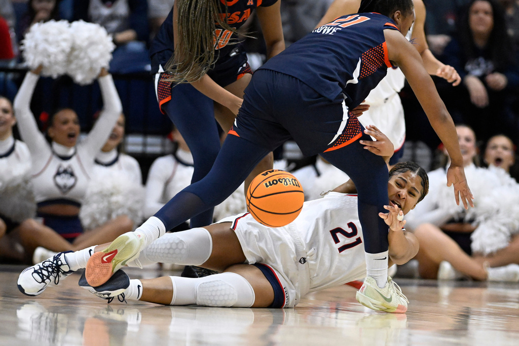 UConn forward Sarah Strong (21) passes around UTSA forward Cheyenne Rowe (21) during the first half in the first round of the NCAA college basketball tournament, Saturday, March 21, 2026, in Storrs, Conn. (AP Photo/Jessica Hill)