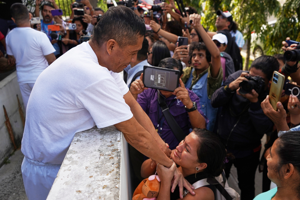 Human rights activist Jose Angel Perez greets his family after being released from jail in Santa Tecla, El Salvador, Wednesday, Dec. 17, 2025. (AP Photo/Salvador Melendez)