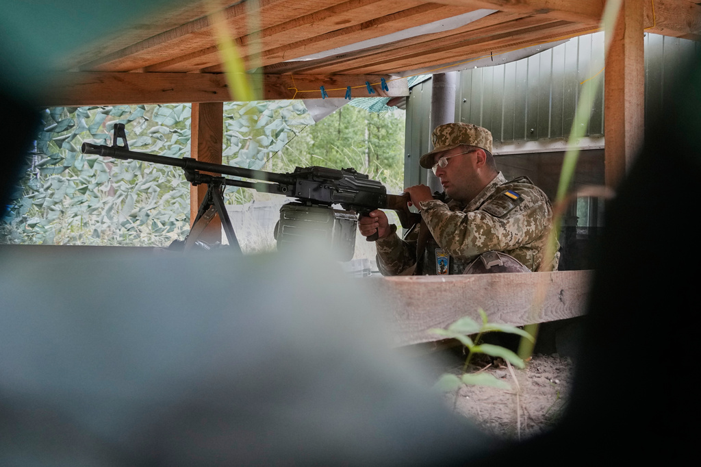 A Ukrainian border guard is on duty at the Ukraine-Belarus border in an undisclosed location in Ukraine Tuesday, July 7, 2026. (AP Photo/Efrem Lukatsky)