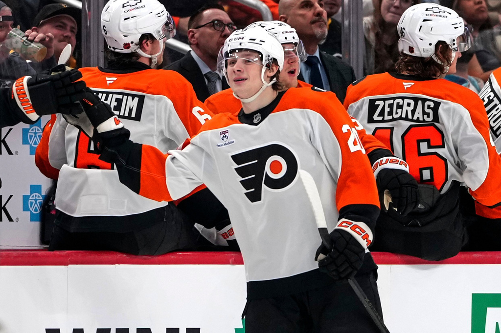 Philadelphia Flyers' Alex Bump, center, returns to the bench after scoring during the second period of an NHL hockey game against the Pittsburgh Penguins in Pittsburgh, Saturday, March 7, 2026. (AP Photo/Gene J. Puskar)