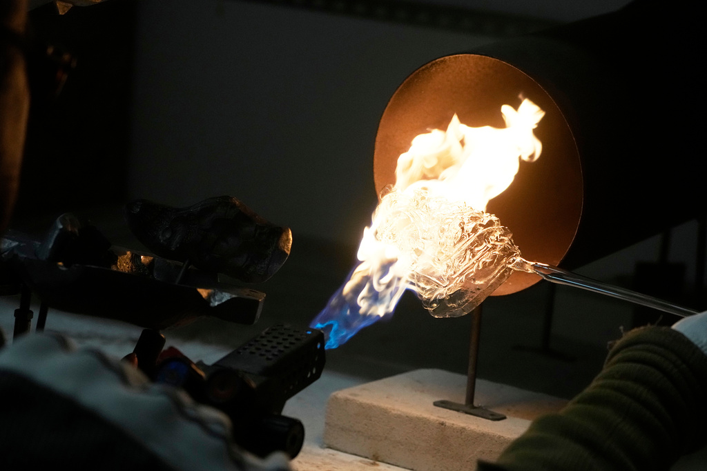 A worker prepares a hand-made Christmas bauble at GlitterLab in Czestochowa, southern Poland, on Nov. 21, 2025. (AP Photo/Czarek Sokolowski)