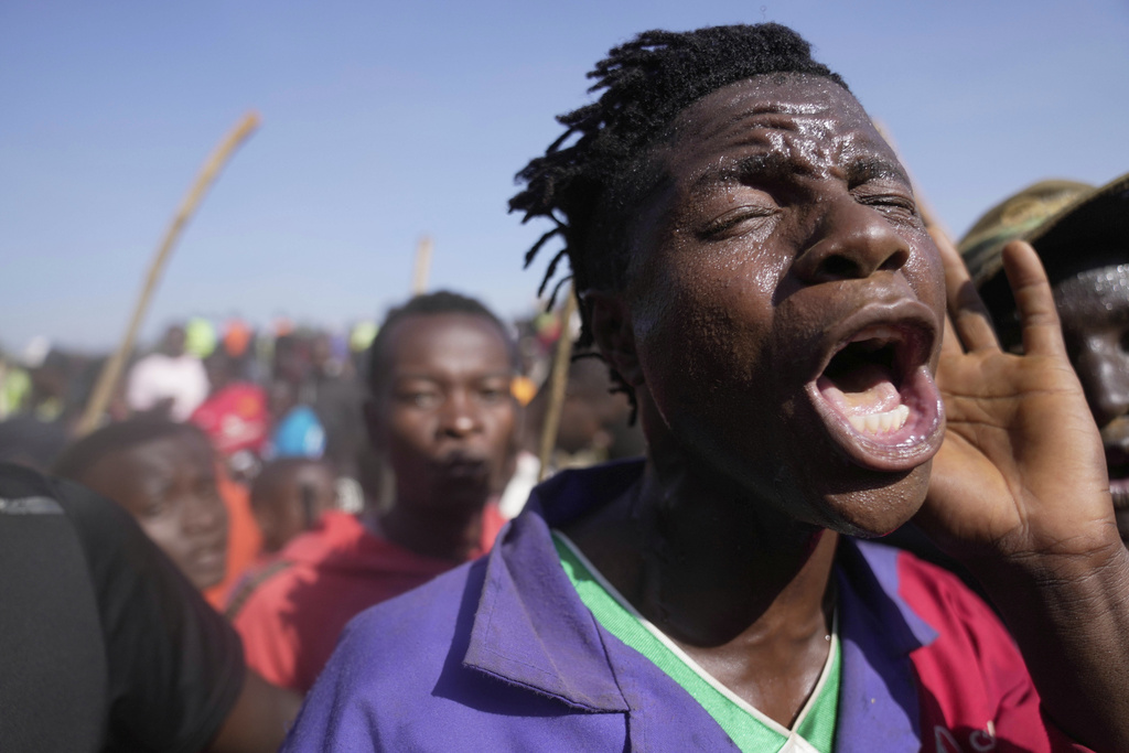 A spectator dances and sings after bull Shakahola won bullfighting match, in Kakamega, Kenya, Saturday, Nov. 29, 2025. (AP Photo/Brian Inganga)