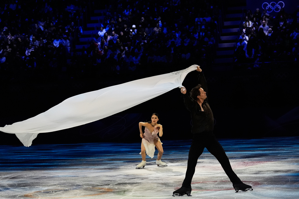 Madison Chock and Evan Bates of the United States perform during the figure skating exhibition at the 2026 Winter Olympics, in Milan, Italy, Saturday, Feb. 21, 2026. (AP Photo/Ashley Landis)