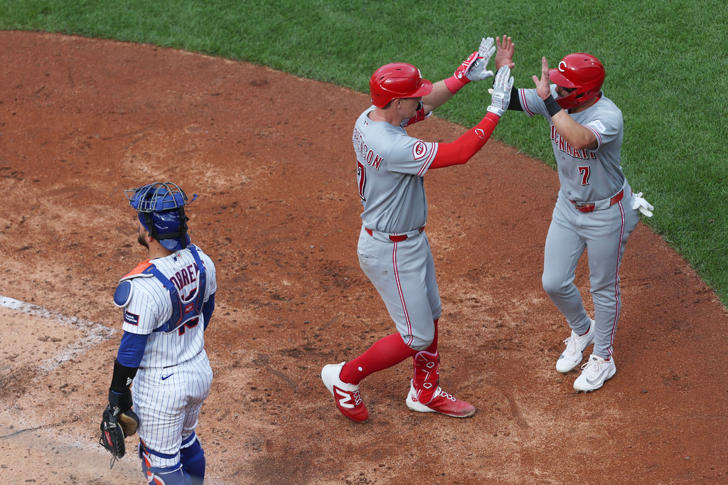 Cincinnati Reds' Tyler Stephenson, center, high-fives Spencer Steer (7) after he hit a home run during the fourth inning of a baseball game against the New York Mets, Monday, May 25, 2026, in New York. (AP Photo/Heather Khalifa)