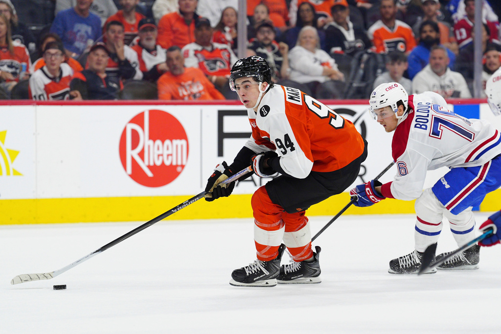 Philadelphia Flyers' Porter Martone skates the puck past Montréal Canadiens' Zachary Bolduc (76) during the second period of an NHL hockey game, Tuesday, April 14, 2026, in Philadelphia. (AP Photo/Derik Hamilton)