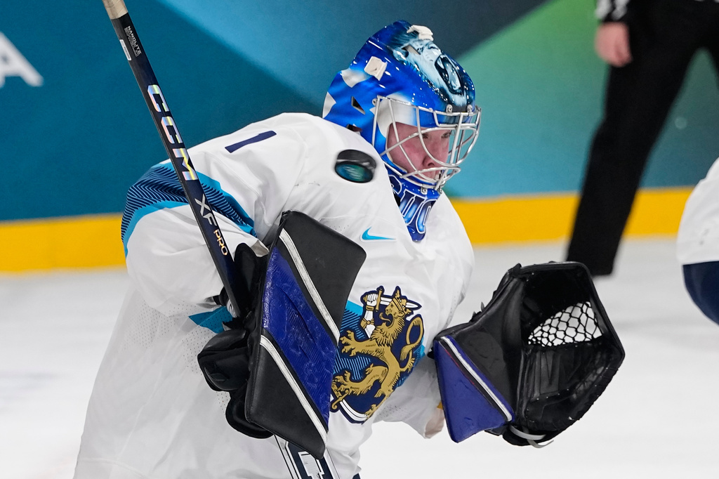 Finland's Sanni Ahola fails to make a save during a preliminary round match of women's ice hockey between the United States and Finland at the 2026 Winter Olympics, in Milan, Italy, Saturday, Feb. 7, 2026. (AP Photo/Petr David Josek)