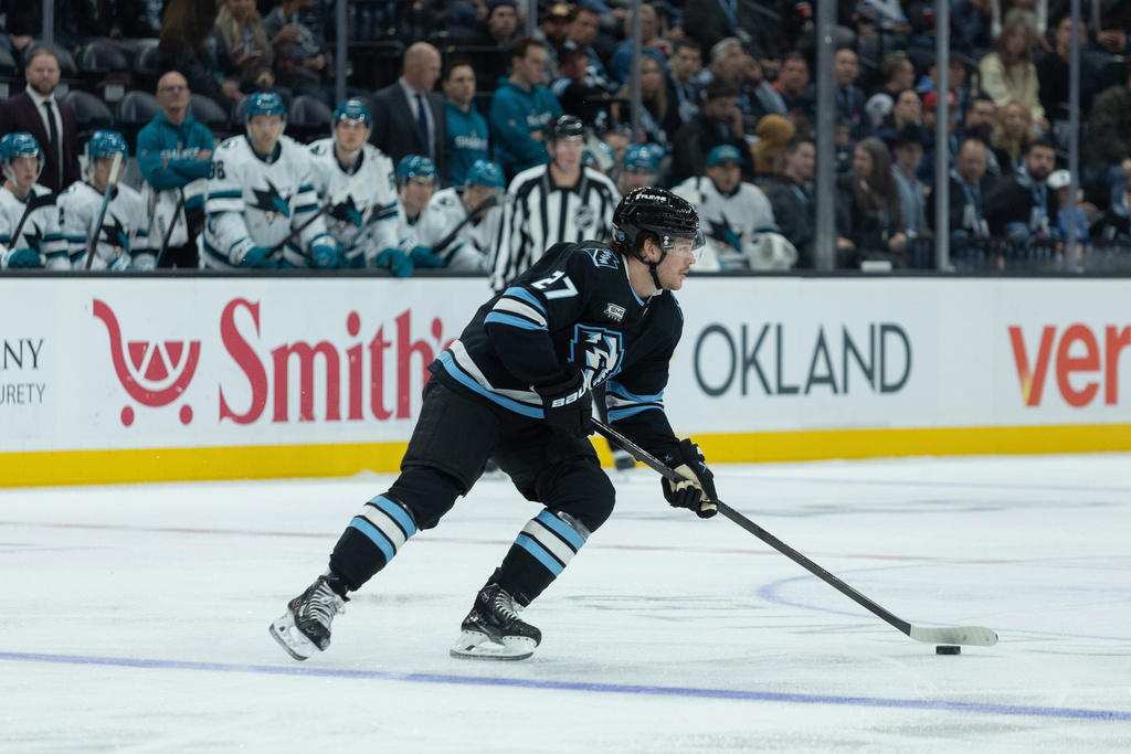 Utah Mammoth center Barrett Hayton (27) skates with the puck against San Jose Sharks during the first period of an NHL hockey game Friday, Oct. 17, 2025, in Salt Lake City. (AP Photo/Melissa Majchrzak)