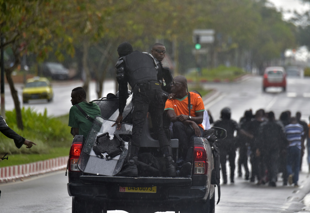 Police arrest a protester during clashes with opposition supporters in Abidjan, Ivory Coast, Saturday, Oct. 11, 2025 (AP Photo/Diomande Ble Blonde)