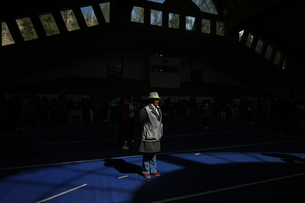 Electoral observer Severina Mamani monitors the presidential runoff election at a polling station in La Paz, Bolivia, Sunday, Oct. 19, 2025. (AP Photo/Natacha Pisarenko)