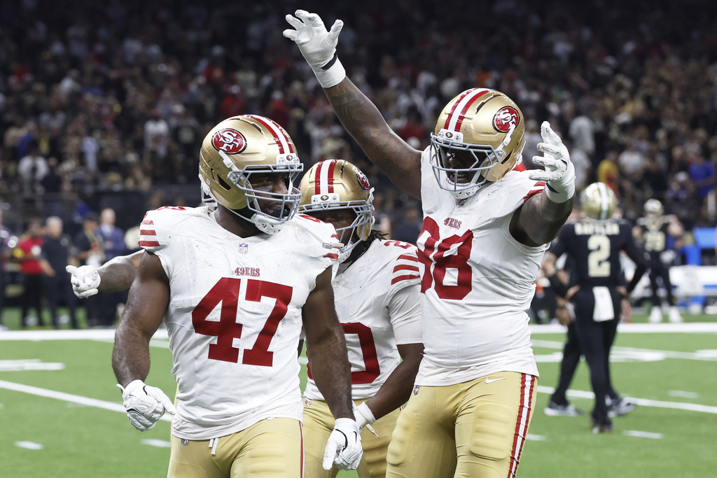 San Francisco 49ers defensive end Bryce Huff (47) celebrates with cornerback Upton Stout, rear, and defensive end Mykel Williams (98) after sacking New Orleans Saints quarterback Spencer Rattler (2) to force a turnover on downs during the second half of an NFL football game in New Orleans, Sunday, Sept. 14, 2025. (AP Photo/Butch Dill)