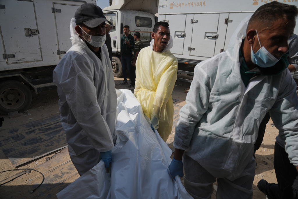 Bodies of unidentified Palestinians returned from Israel as part of the ceasefire deal are brought to Nasser Hospital in Khan Younis, Gaza Strip, Wednesday Nov. 5, 2025. (AP Photo/Jehad Alshrafi)