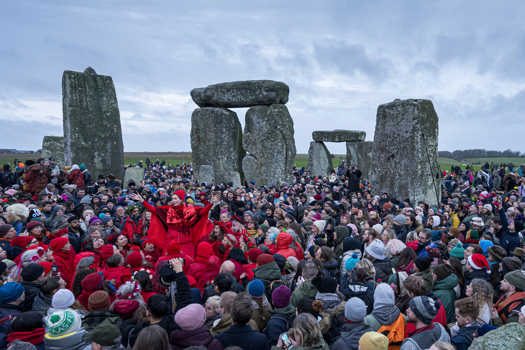 FILE - People celebrate the Winter Solstice sunrise celebrations at Stonehenge, England, Saturday, Dec. 21, 2024. (AP Photo/Anthony Upton, file)