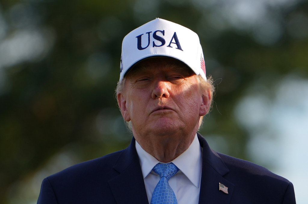 President Donald Trump stands before presenting the Presidents Cup trophy at the Presidents Cup golf tournament at Medinah Country Club, Sunday, Sept. 27, 2026, in Medinah, Ill. (AP Photo/Julia Demaree Nikhinson)
