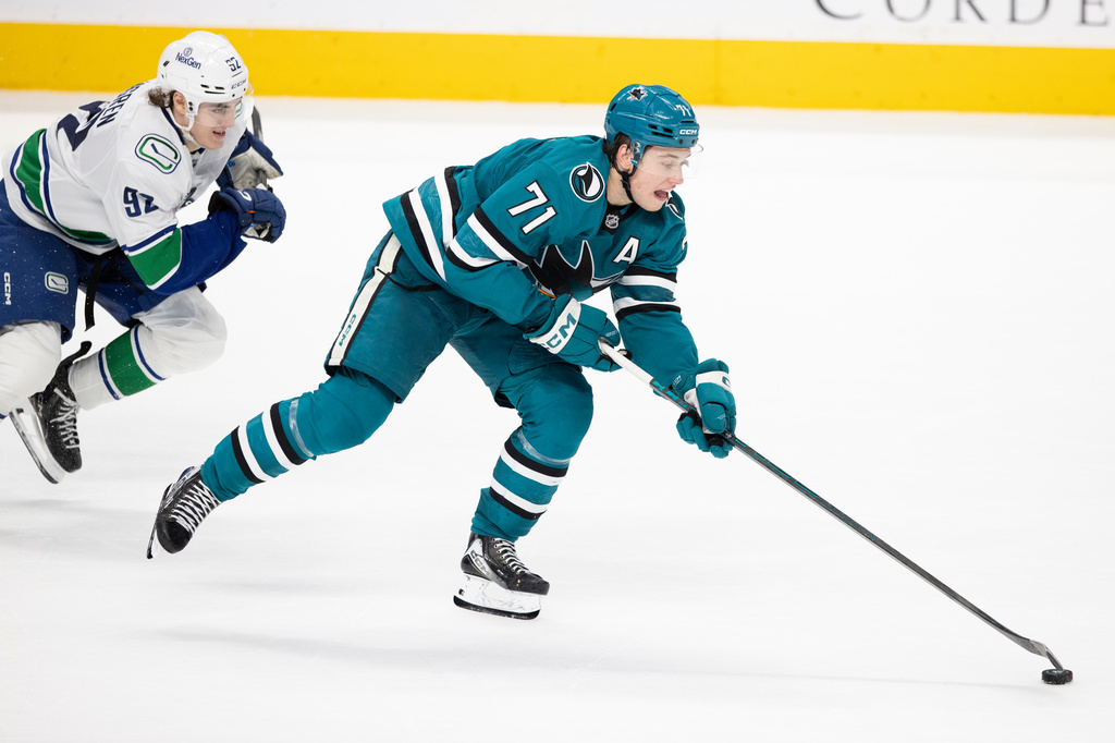 FILE - San Jose Sharks center Macklin Celebrini (71) drives the puck as Vancouver Canucks left wing Liam Ohgren (92) defends during the third period of their NHL ice hockey game in San Jose, Calif., Saturday, April 11, 2026. (Stephen Lam/San Francisco Chronicle via AP)