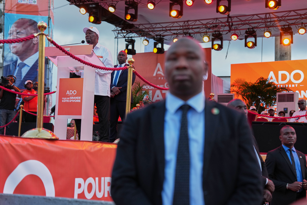 President Alassane Ouattaral, left, addresses supporters during his final campaign rally at Republic Square in Abidjan, Ivory Coast, Thursday, Oct. 23, 2025. (AP Photo/Misper Apawu)