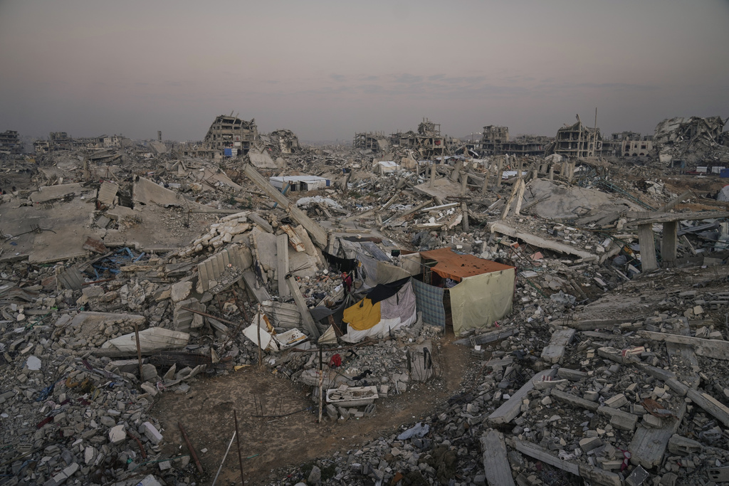 A makeshift tent stands amid widespread devastation in Gaza City Thursday, Nov. 27, 2025. (AP Photo/Jehad Alshrafi)