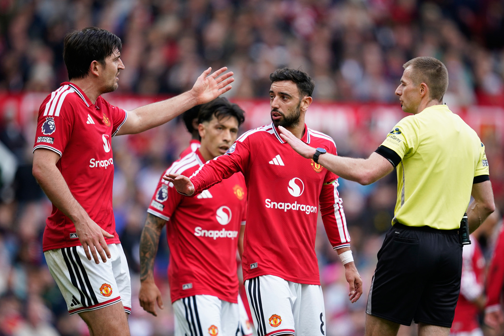 Manchester United's Harry Maguire, left, argues with referee Michael Salisbury during the English Premier League soccer match between Manchester United and Nottingham Forest in Manchester, England, Sunday, May 17, 2026. (AP Photo/Dave Thompson)