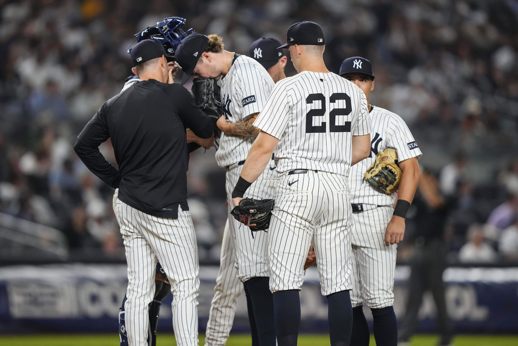 New York Yankees pitcher Cam Schlittler and teammates talk during the fourth inning of a baseball game against the Minnesota Twins, Wednesday, Aug. 13, 2025, in New York. (AP Photo/Yuki Iwamura)