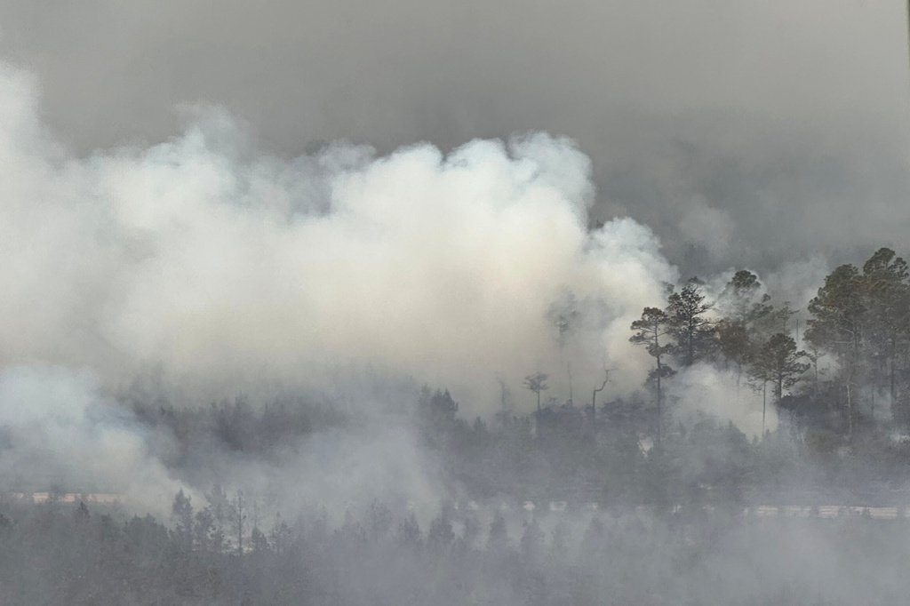 The photo provided by the Office of Gov. Brian Kemp shows smoke produced by a wildfire in Brantley County, Ga., Friday, April 24, 2026. (Office of Gov. Brian Kemp via AP)