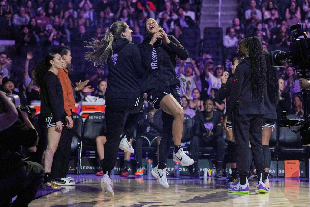 Golden State Valkyries guard Veronica Burton, center right, is greeted by Kate Martin, center left, while being introduced before a WNBA basketball game against the Indiana Fever, Sunday, Aug. 31, 2025, in San Francisco. (AP Photo/Godofredo A. Vásquez)