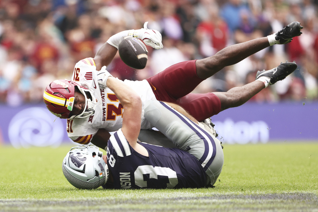 Iowa State Marcus Neal Jr., up, tackles Kansas State Will Swanson during an NCAA college football game between Iowa State and Kansas State in Dublin, Ireland Saturday, Aug. 23, 2025. (AP Photo/Peter Morrison)