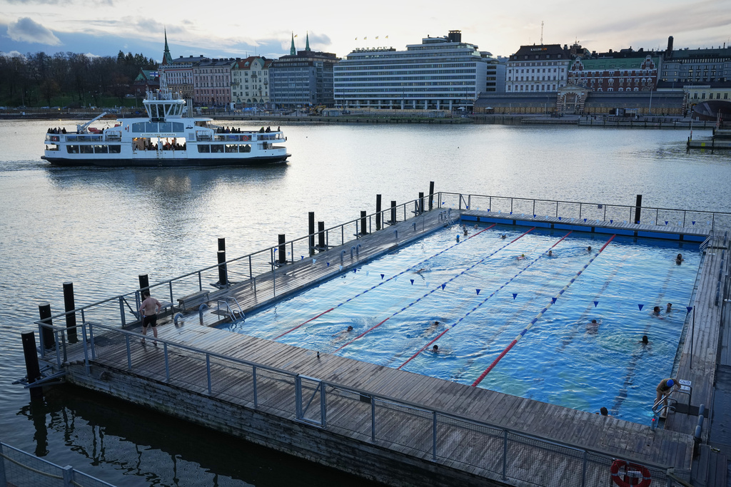 People enjoy in a public pool in Helsinki, Finland, Friday, Nov. 14, 2025. (AP Photo/Sergei Grits)