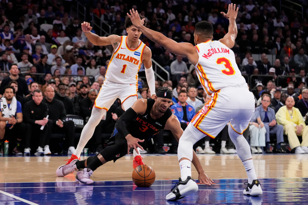 New York Knicks guard Josh Hart (3) falls as he attempts to drive past Atlanta Hawks guard CJ McCollum (3) during the first half in Game 2 of a first-round NBA playoffs basketball series, Monday, April 20, 2026, in New York. (AP Photo/Yuki Iwamura)