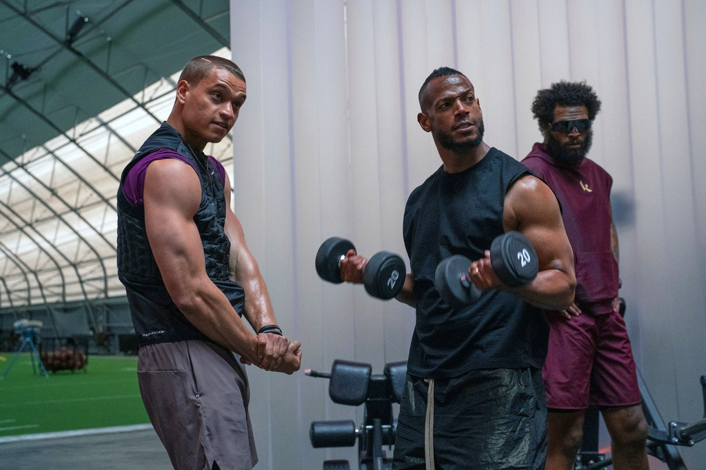 This image released by Universal Pictures shows Tyriq Withers, left, and Marlon Wayans in a scene from "Him." (Parrish Lewis/Universal Pictures via AP)
