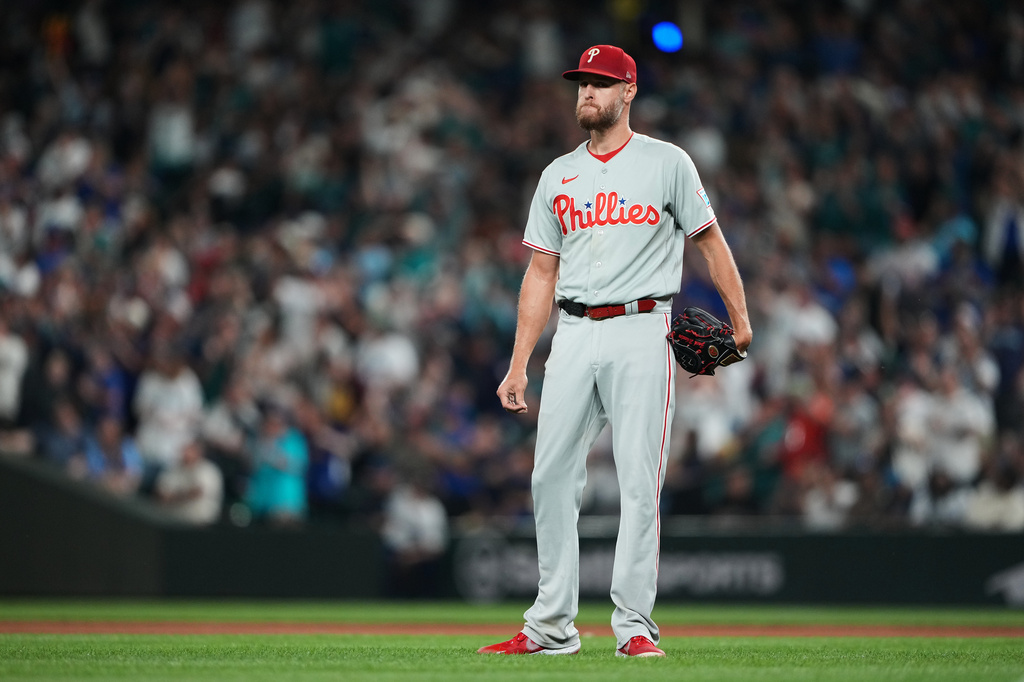 Philadelphia Phillies starting pitcher Zack Wheeler reacts after giving up back-to-back home runs to Seattle Mariners' Cal Raleigh and Cole Young during the fifth inning of a baseball game, Monday, Aug. 24, 2026, in Seattle. (AP Photo/Lindsey Wasson)
