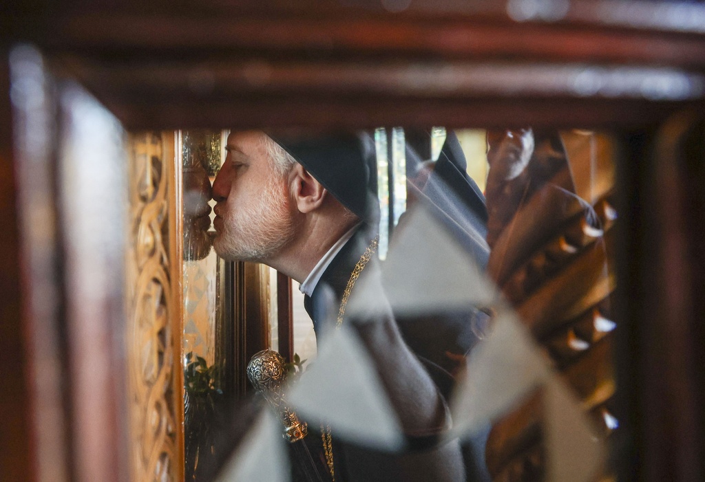 His Eminence Archbishop Elpidophoros of the Greek Orthodox Archdiocese of America venerates an icon moments after arriving at the Saint Nicholas Greek Orthodox Cathedral during the 120th Epiphany celebration on Tuesday, Jan 6, 2026, in Tarpon Springs, Fla. (Jefferee Woo /Tampa Bay Times via AP)