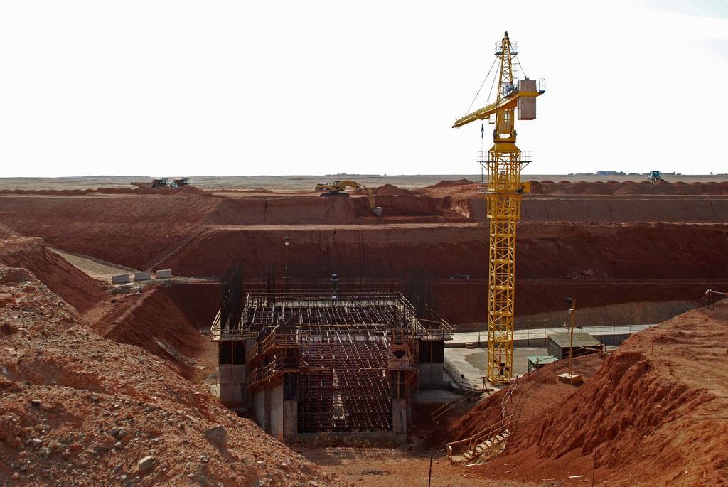 FILE - A crane hovers above the site of a new shaft under construction at the Oyu Tolgoi mine site in Khanbogd village, Umnugobi province, Mongolia, Nov. 7, 2009. (AP Photo/Ganbat Namjilsangarav, File)