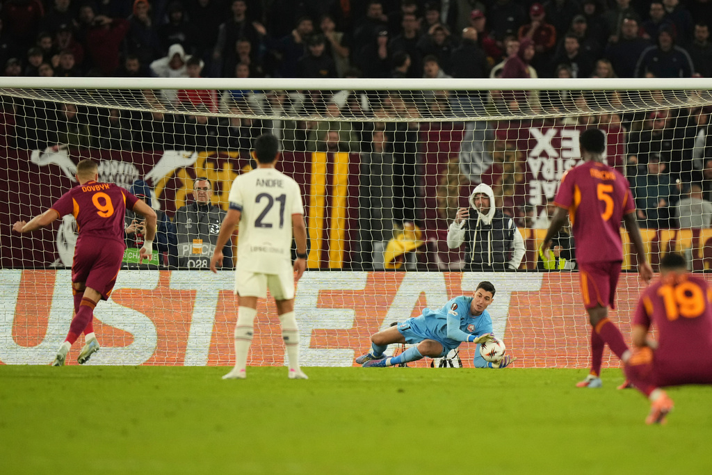 Lille goalkeeper Mile Svilar saves a penalty kicked by Roma's Artem Dovbyk during the Europa League Europa League soccer match between AS Roma and Lille at the Olympic stadium in Rome, Thursday, Oct. 2, 2025. (AP Photo/Andrew Medichini)