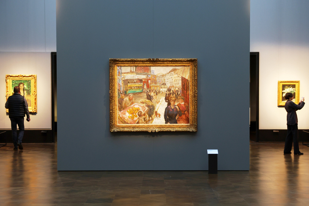 Journalists walks next to the painting "Place Clichy" from 1867-1947 by Pierre Bonnard during the press preview for the exhibition "The Scharf Collection: Goya – Monet – Cezanne – Bonnard – Grosse" at the Alte Nationalgalerie museum in Berlin, Wednesday, Oct. 22, 2025. (AP Photo/Maryam Majd)