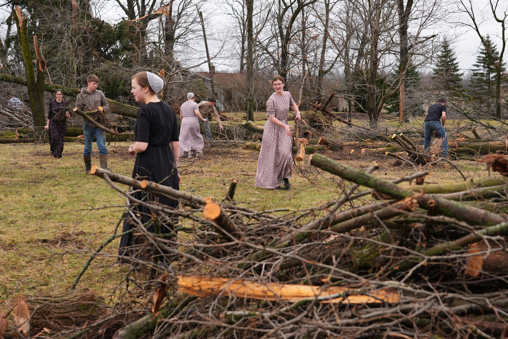 Volunteers work to clear branches after a suspected tornado hit the area a day earlier in Union City, Mich., Saturday, March 7, 2026. (AP Photo/Nam Y. Huh)